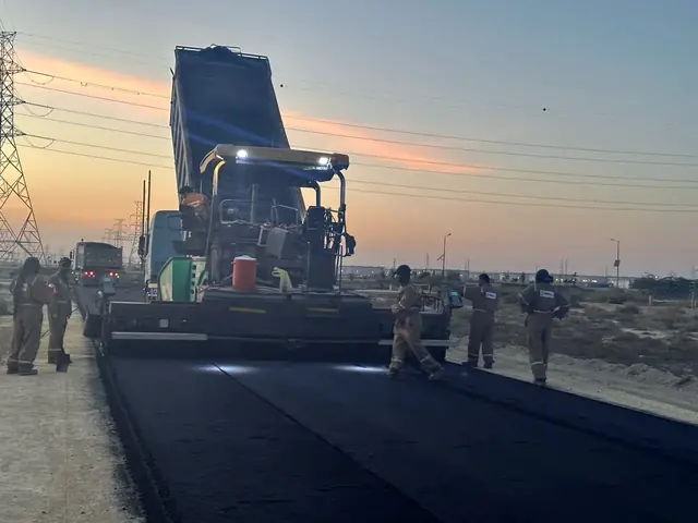 Asphalt paving at dusk — Ras Tanura